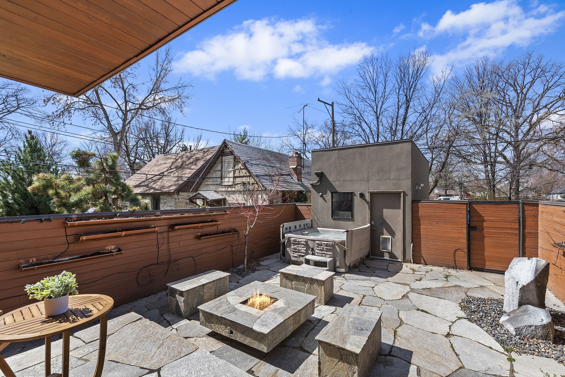 Private walled courtyard with hot tub and gas fire pit at a Boise North End vacation rental